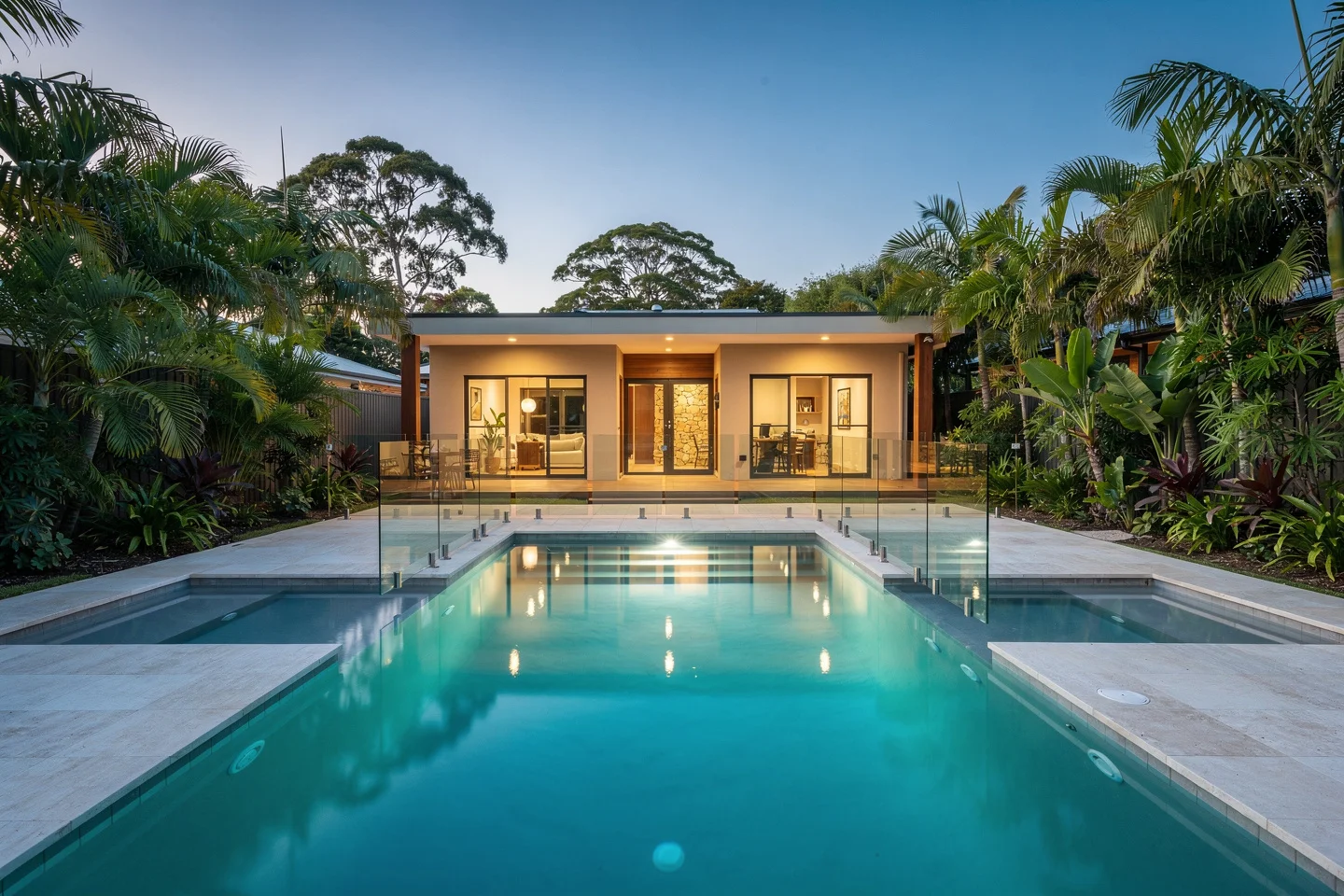 Finished family pool and level terrace on the completed Buderim block at dusk